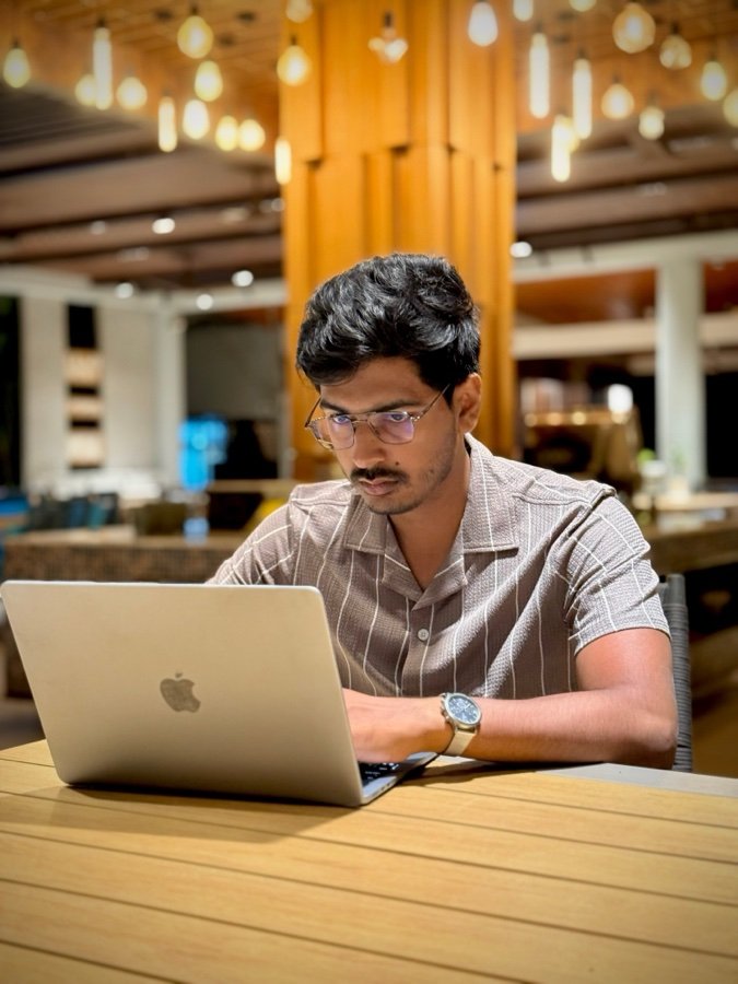 Istiak Ahmed working on MacBook as Fiverr Top Rated Seller video editor
